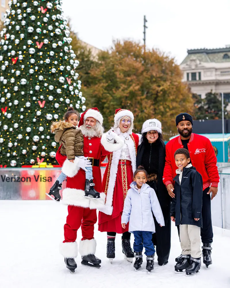 A family posing with Santa and Mrs. Claus on the ice